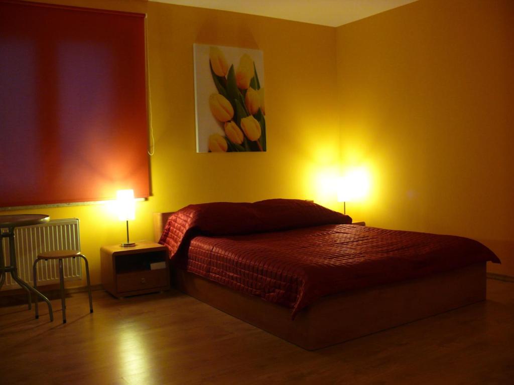 a bedroom with a bed with two lamps on it at Apartamenty Pokoje DreamZone in Lublin