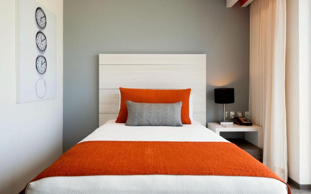 Postel nebo postele na pokoji v ubytování Real Inn Cancún