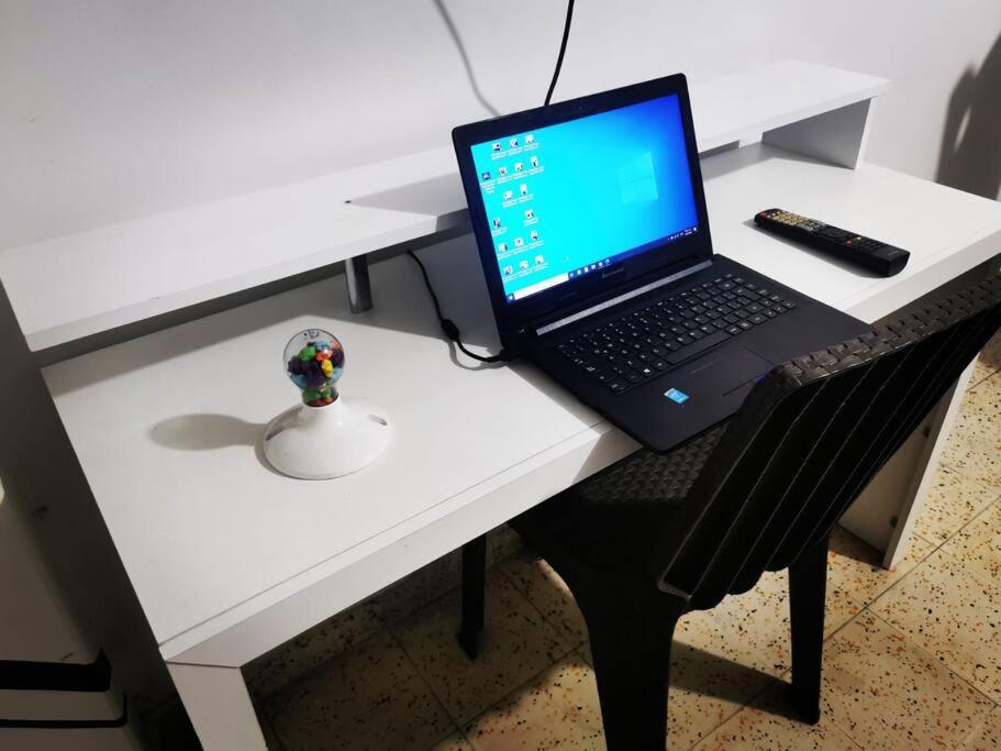 a laptop computer sitting on top of a white desk at Hermoso apartamento en el centro histórico de San Gil I 2 in San Gil