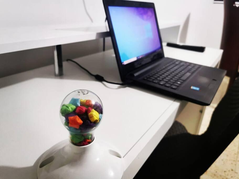 a glass ball on a table next to a laptop at Hermoso apartamento en el centro histórico de San Gil I 2 in San Gil