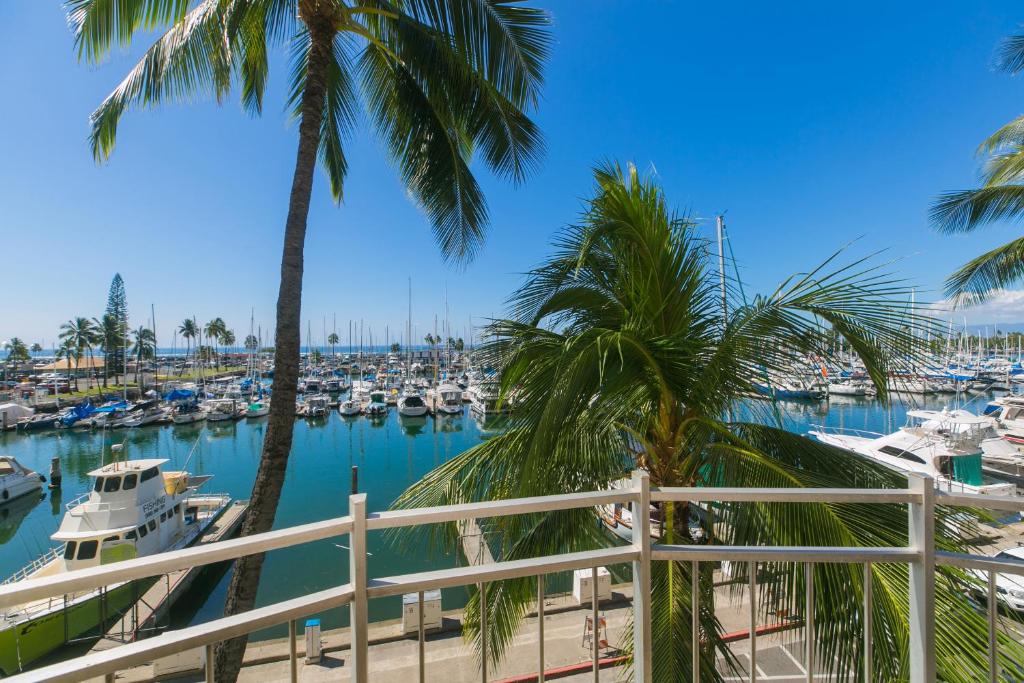 a view of a marina with palm trees and boats at Ilikai Marina 382 Yacht Harbor View 1BR in Honolulu