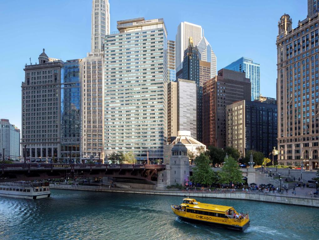 a yellow boat in a river in a city at The Royal Sonesta Chicago Downtown in Chicago