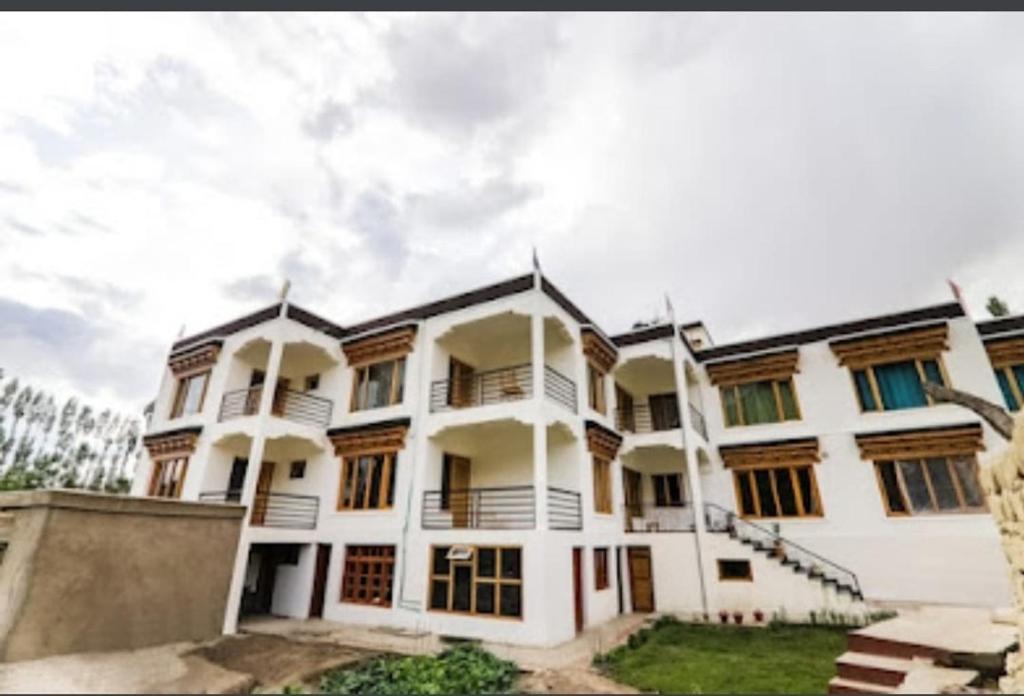 a large white building with a ramp in front of it at Nima's Villa in Leh