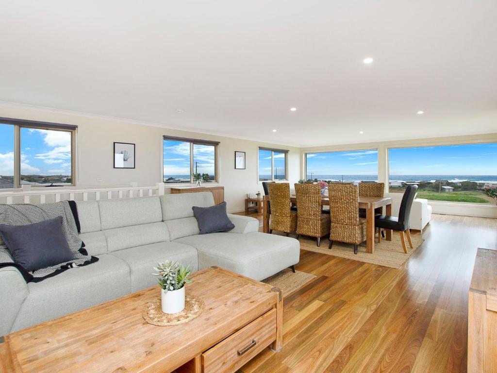 a living room with a couch and a table at Ocean Mist in Port Fairy
