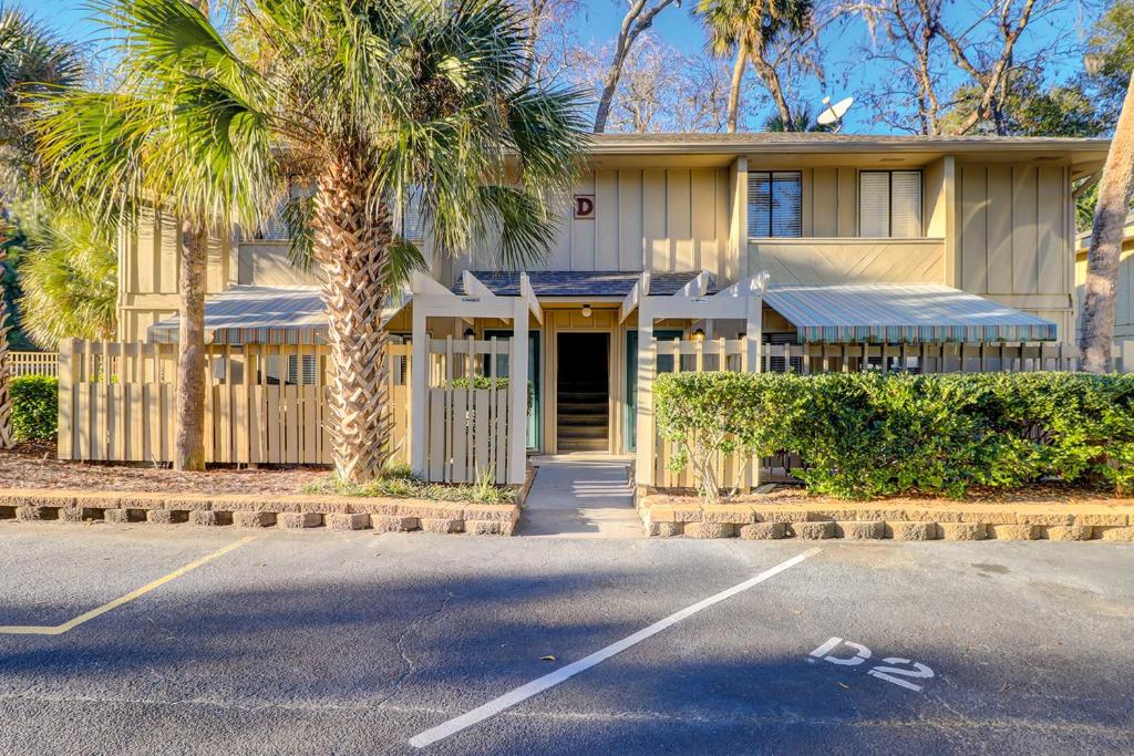 a building with palm trees in front of a parking lot at Dunes Villas in Hilton Head Island