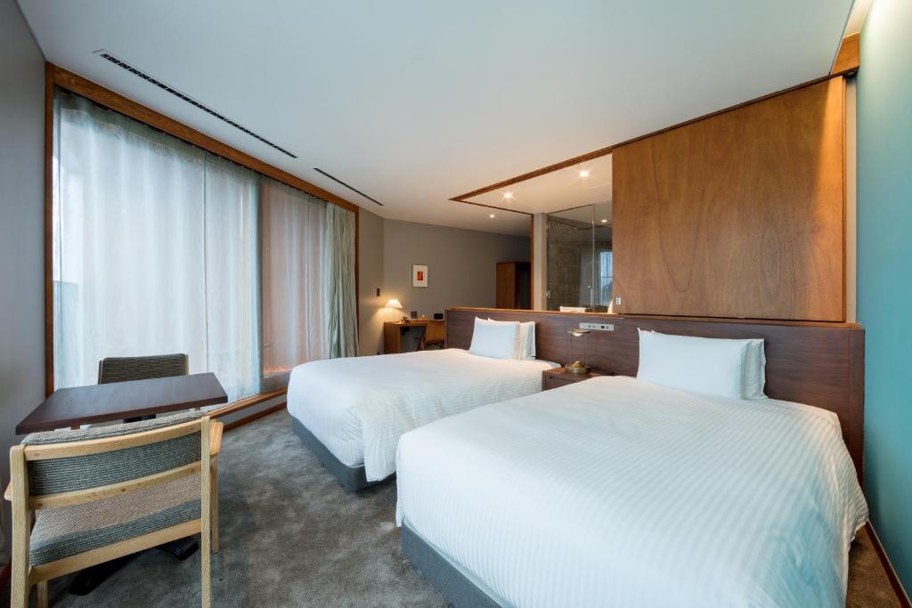 Postel nebo postele na pokoji v ubytování HOTEL AO KAMAKURA