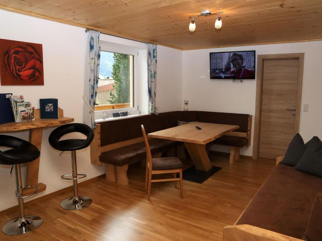 A television and/or entertainment centre at Apartment in Bramberg am Wildkogel with balcony