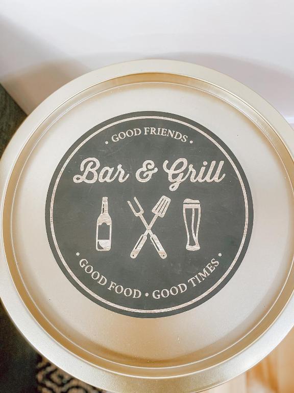 a plate with a bar and grill sign on it at Complexe LIVTremblant by Gestion ELITE - LIV6 in Mont-Tremblant