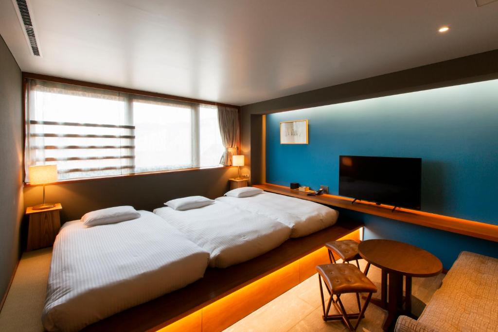 Postel nebo postele na pokoji v ubytování HOTEL AO KAMAKURA