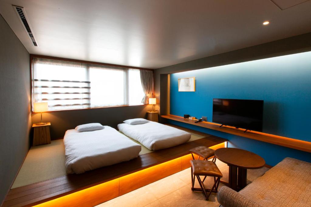 Postel nebo postele na pokoji v ubytování HOTEL AO KAMAKURA