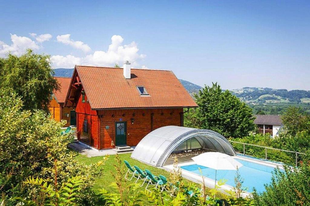 a house with a swimming pool in front of it at Holiday Village, Schlierbach in Schlierbach