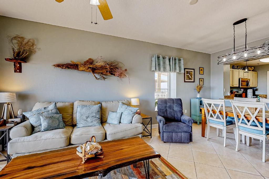 a living room with a couch and a table at Waterside Village 404 - Sea Dragon in Mexico Beach