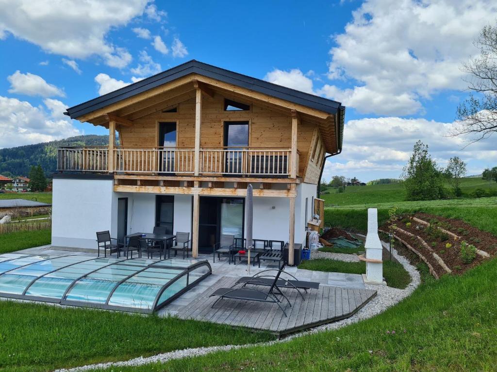 a log house with a deck and a balcony at Chalet Gamsknogel, Inzell in Inzell