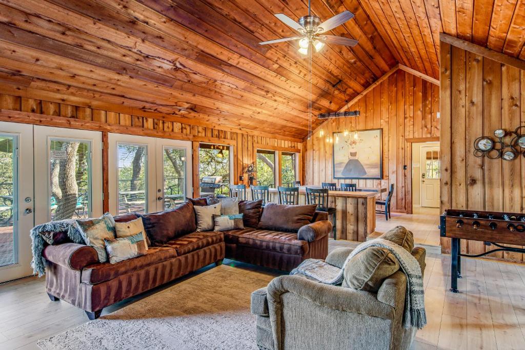 a living room with couches and a wooden ceiling at Stargazer Ridge in Dripping Springs
