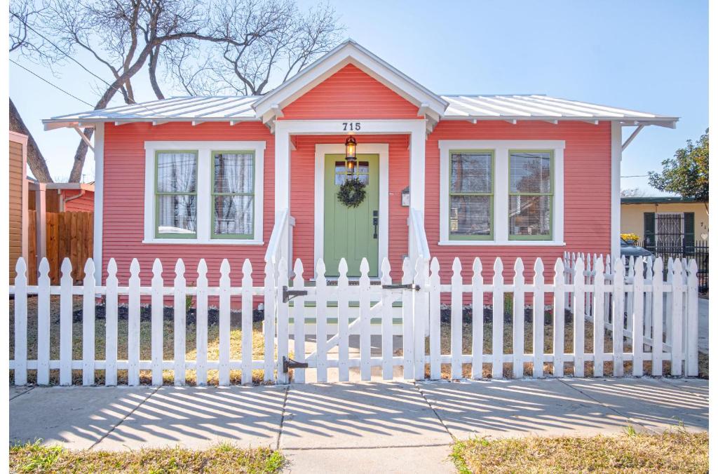una casa roja con una valla blanca en Dazzling 3 BR2 BA Home Near Downtown Tower Americas en San Antonio