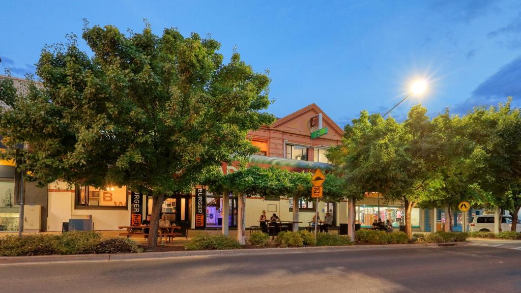 a street with trees in front of a building at Broadway Hotel in Parkes