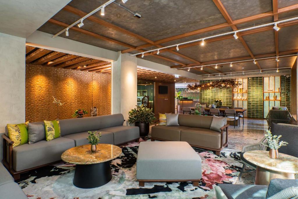 A generous lobby lounge with sofas, tables and layered warm lighting.