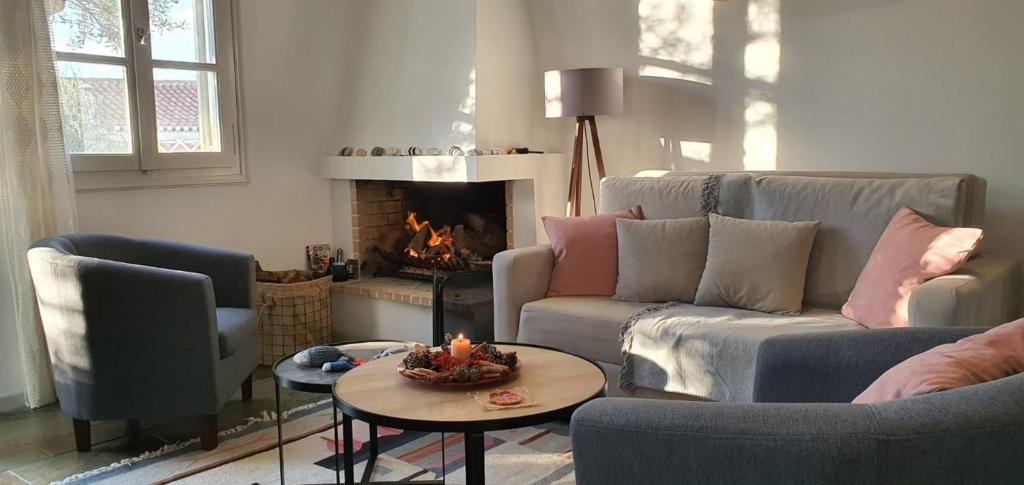 a living room with a couch and a fire place at Aria House in Spetses