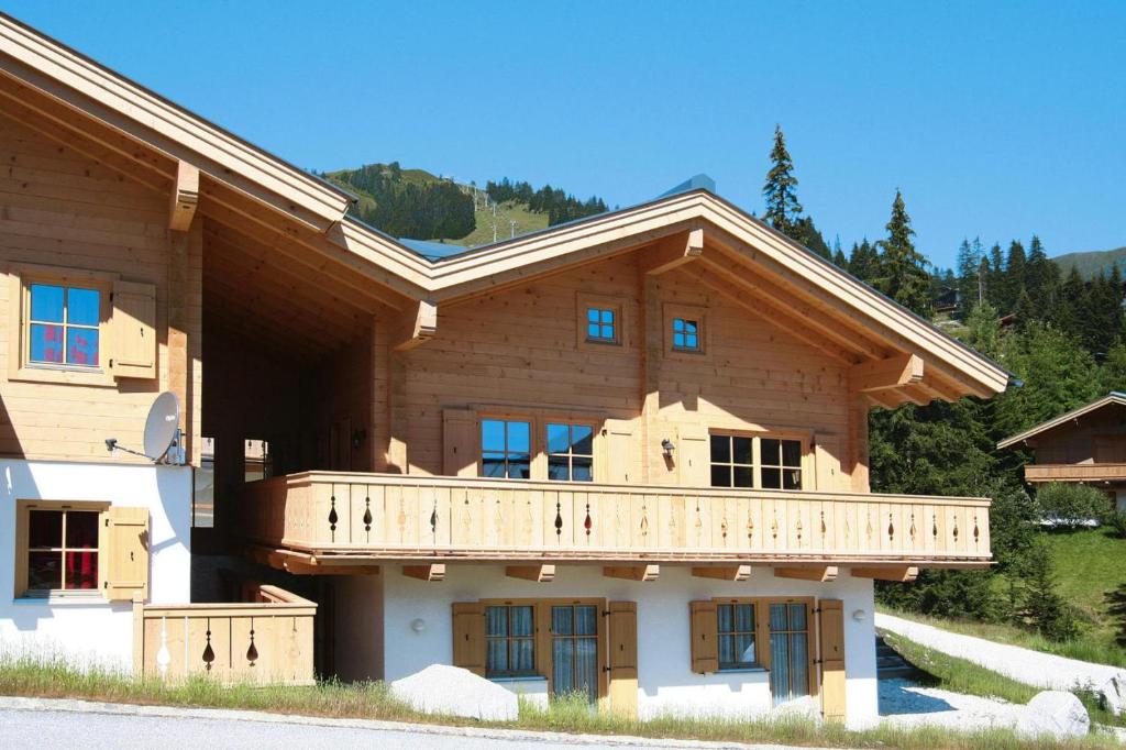 a large wooden house with a balcony on it at Chalet, Königsleiten in Königsleiten