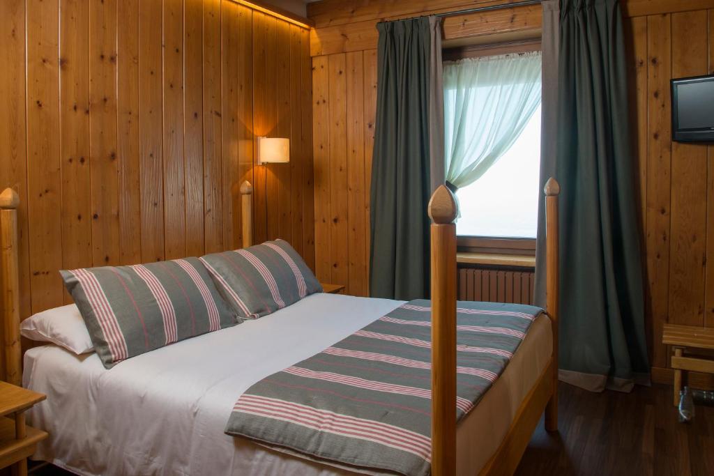 Postel nebo postele na pokoji v ubytování Albergo Ristorante Bucaneve