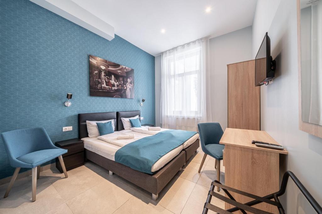 a bedroom with a bed and a desk at Full Moon Budapest in Budapest