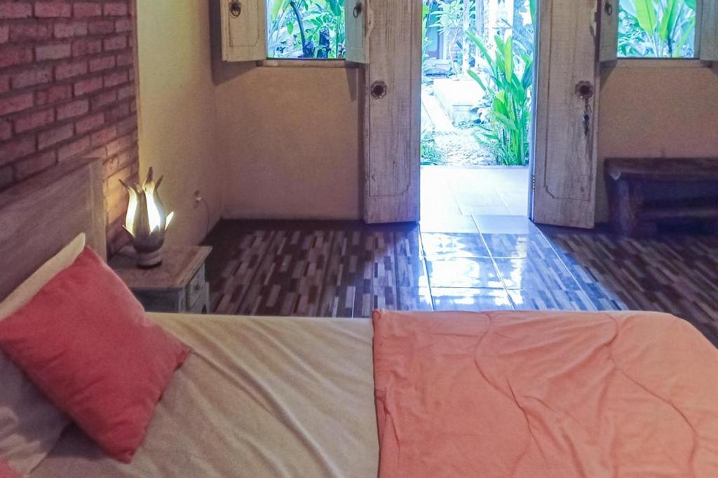 Postel nebo postele na pokoji v ubytování Pranajaya Villa