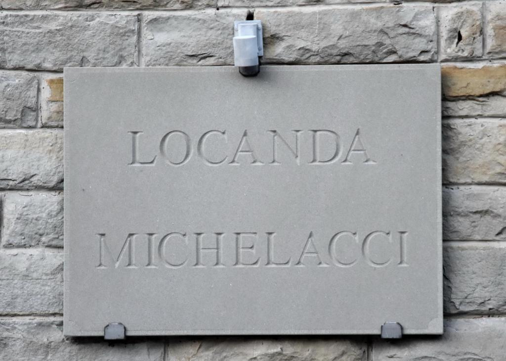 un cartel en una pared de ladrillo con el nombre de un hospital en Locanda Michelacci, en Corniolo