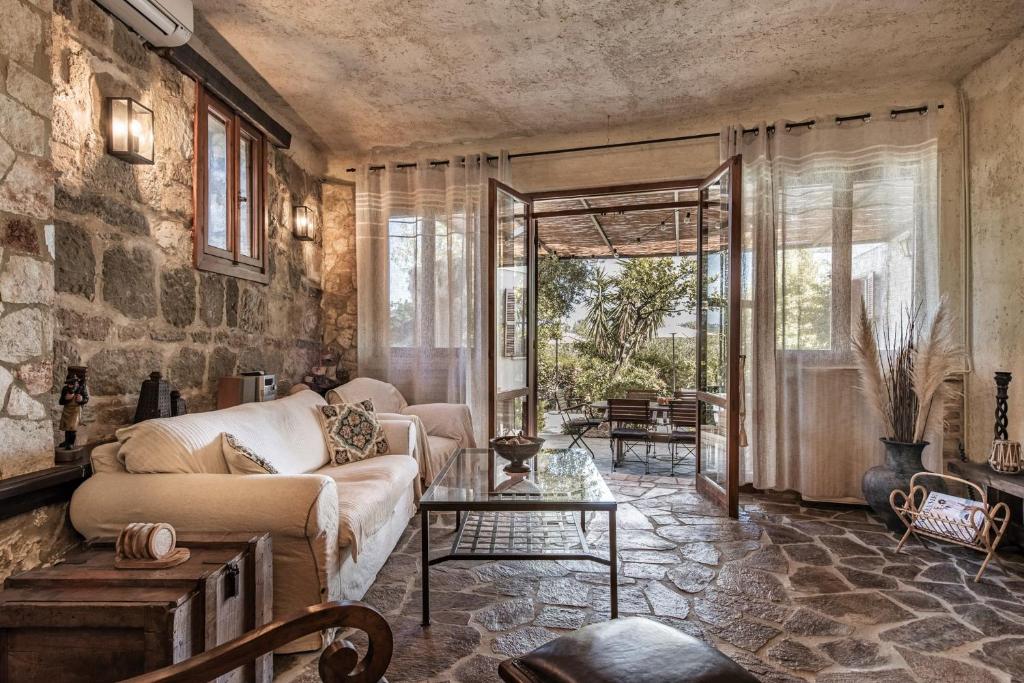 a living room with a couch and a table at Villa Gioia - Secret gem with private garden in Katastárion
