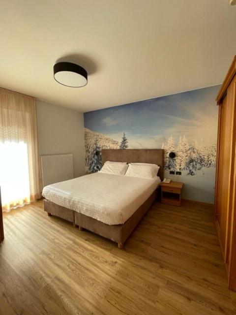 Postel nebo postele na pokoji v ubytování Hotel Rosa Alpina