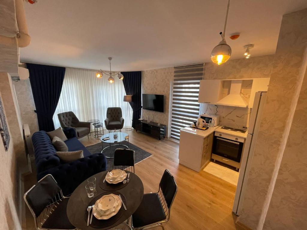 a living room with a couch and a table and chairs at King Suite AN9 in Istanbul