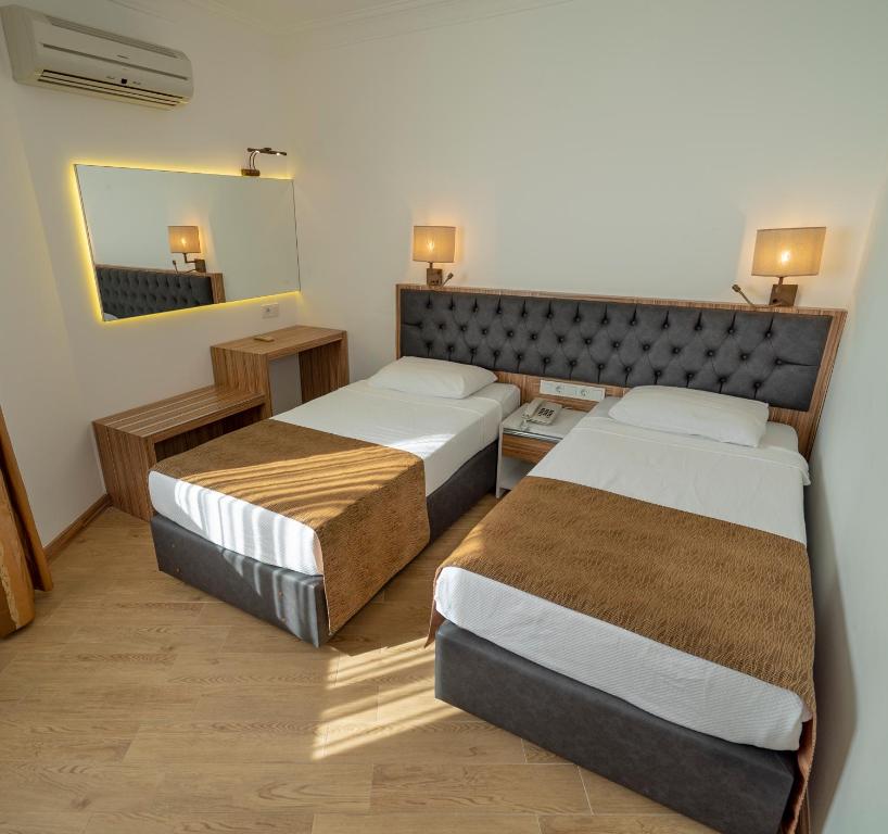 A bed or beds in a room at Kleopatra Celine Hotel