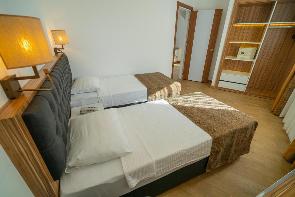 A bed or beds in a room at Kleopatra Celine Hotel