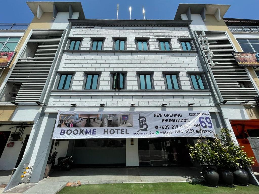 a building with a banner on the front of it at BOOKME HOTEL in Johor Bahru