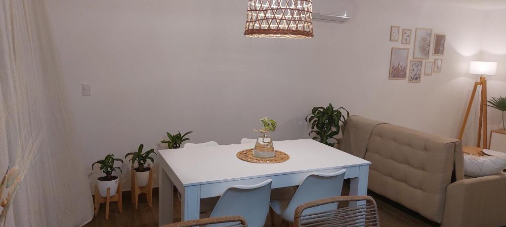 a living room with a white table and a couch at Espacio arredondo castelar in Castelar