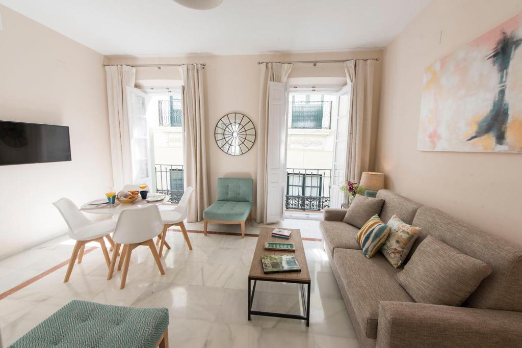 a living room with a couch and a table at Céntriko Apartments Quintero 40 in Seville