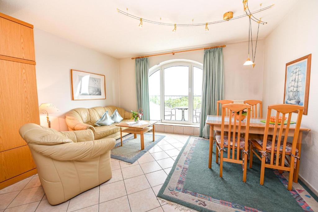 a living room with a couch and a table at "Appartementhaus Deichgraf" Appartement D341 in Döse