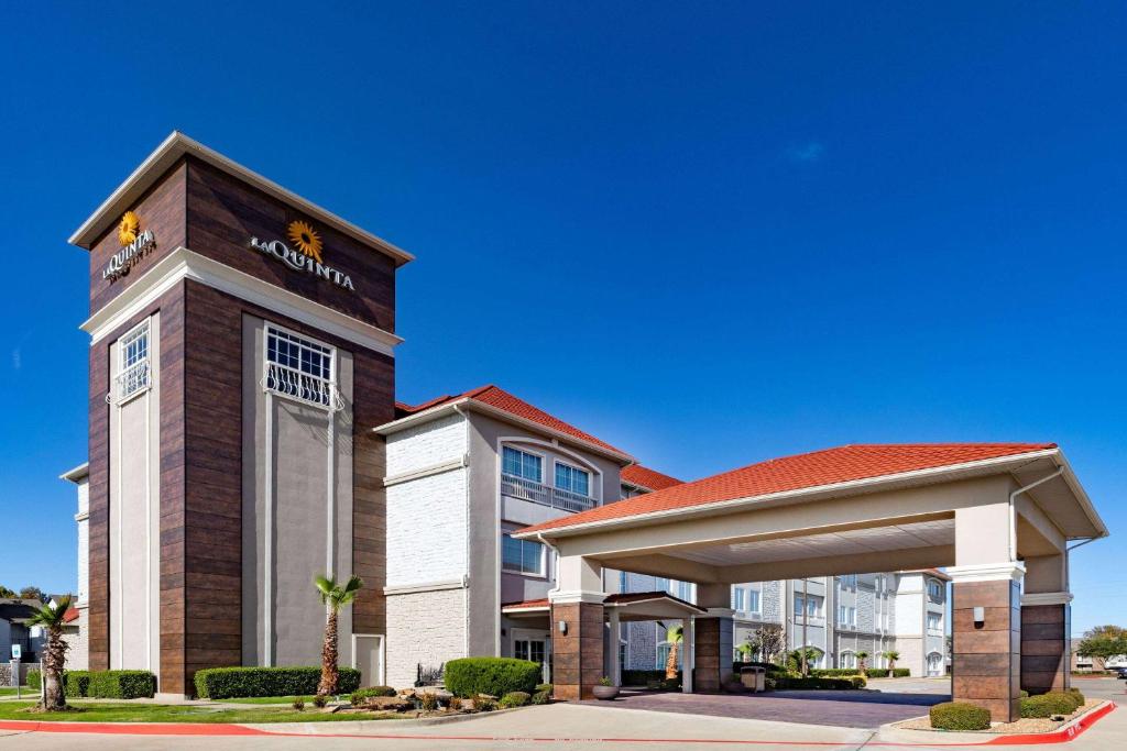 a hotel with a sign on the front of a building at La Quinta by Wyndham Garland Harbor Point in Garland