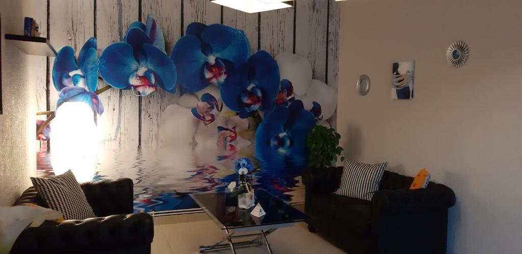 a living room with two chairs and a balloon wall at Hotel Saint François Précigné Soirée étape sur demande Proche Sablé-sur-Sarthe in Précigné