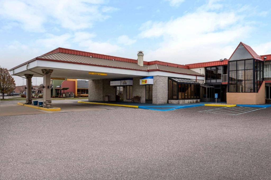 a gas station with a large building at Days Inn by Wyndham Perrysburg Toledo in Perrysburg