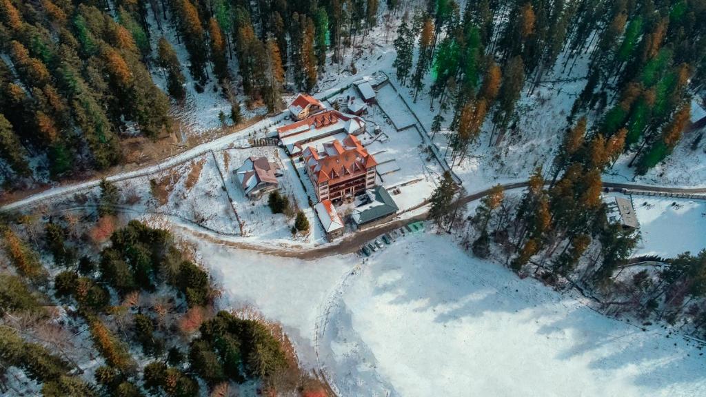 an aerial view of a house in the snow at Hotel Cumpatu in Sinaia
