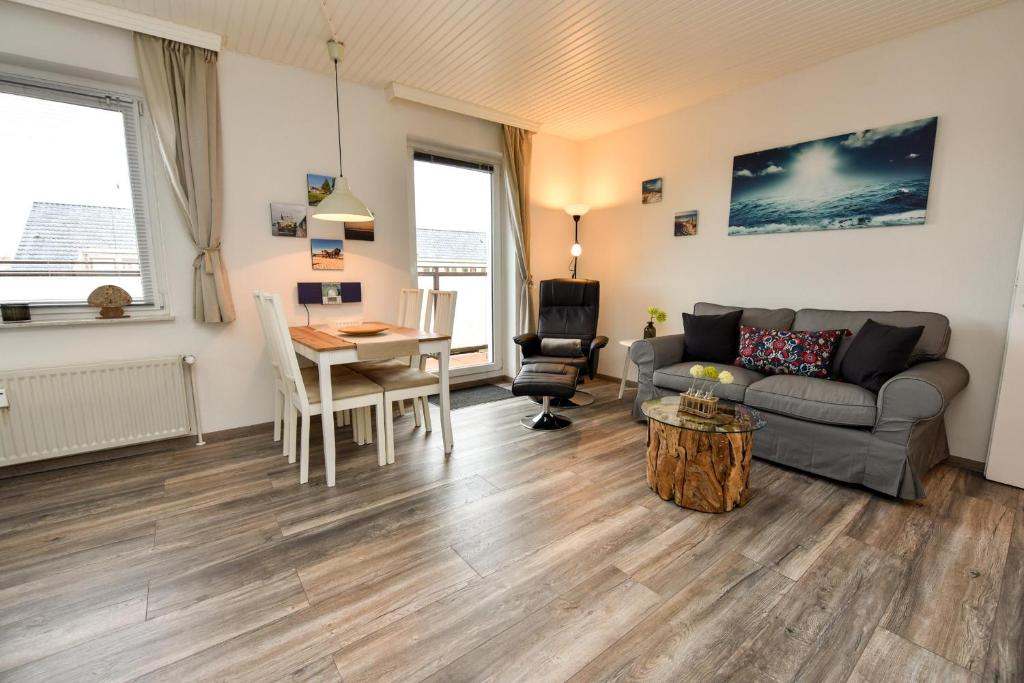 a living room with a couch and a table at Haus "Najade" Appartement NAJA8 in Döse