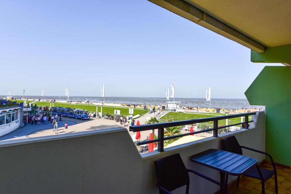 a balcony with a view of the beach and the ocean at Haus "Panorama" Appartement PAN019 in Duhnen