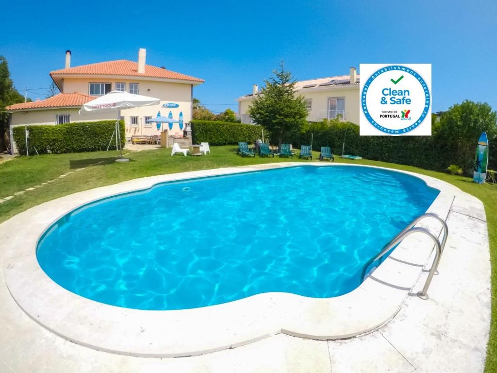 a swimming pool in the backyard of a house at Carcavelos Surf Hostel & Surf Camp in Carcavelos