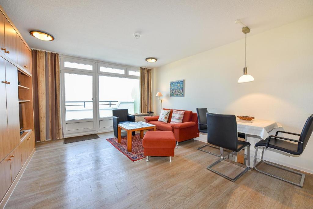 a living room with a couch and a table at Haus "Panorama" Appartement PAN027 in Duhnen