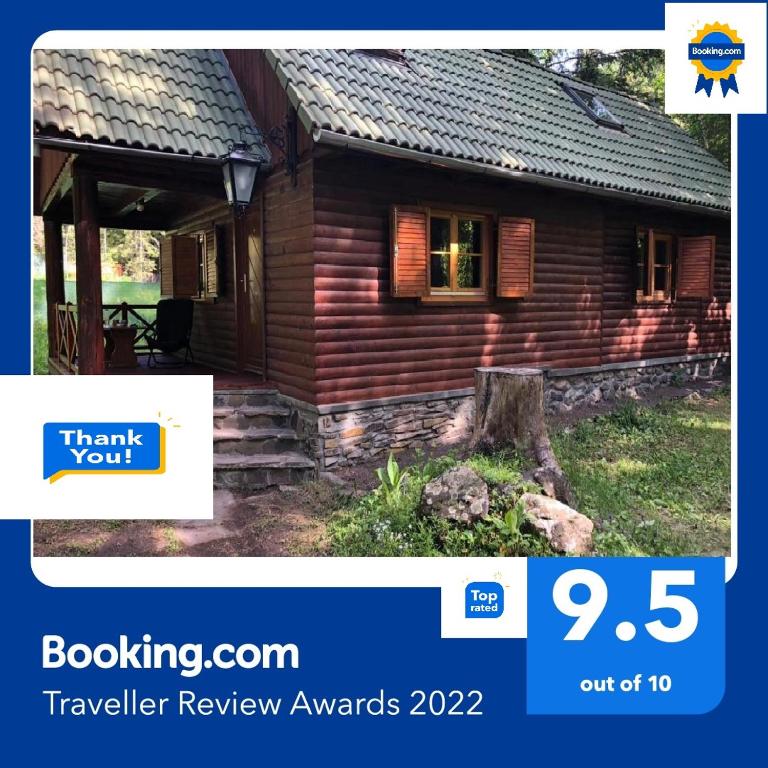 a picture of a log cabin with the words travel review awards at Forest Cottage Weekend House in Vlăhiţa