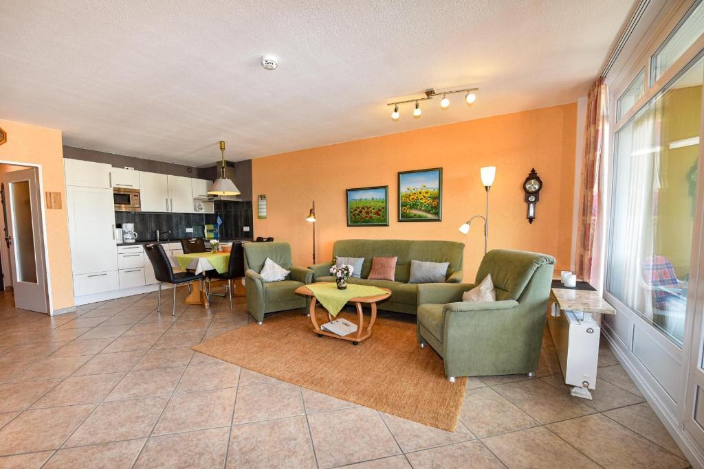 a living room with couches and a table at Haus "Panorama" Appartement PAN102 in Duhnen