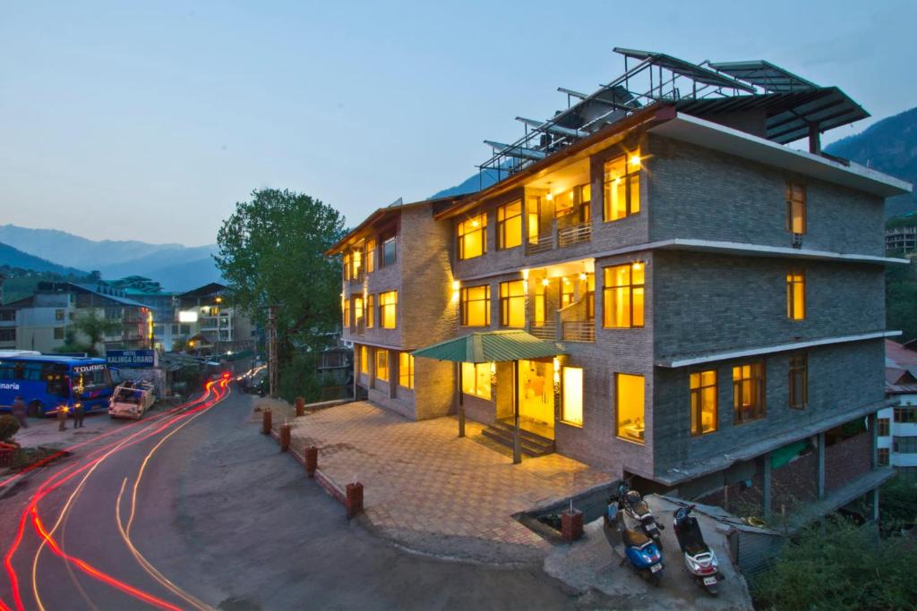 a building on a street with motorcycles parked in front of it at Sarthak Regency by M K Hospitality,Rangri, Manali,HP,Just 1 kms from Volvo parking in Manāli