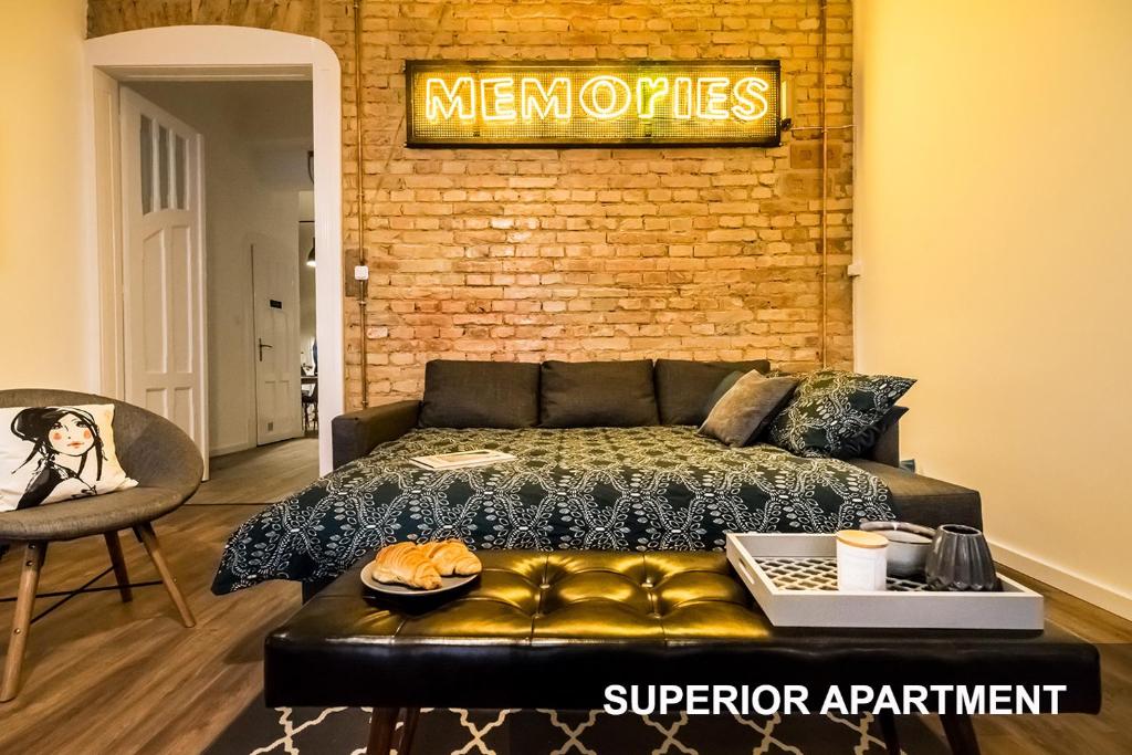a bedroom with a bed and a sign on a brick wall at BpR Whistle Arts Industrial Apartment in Budapest