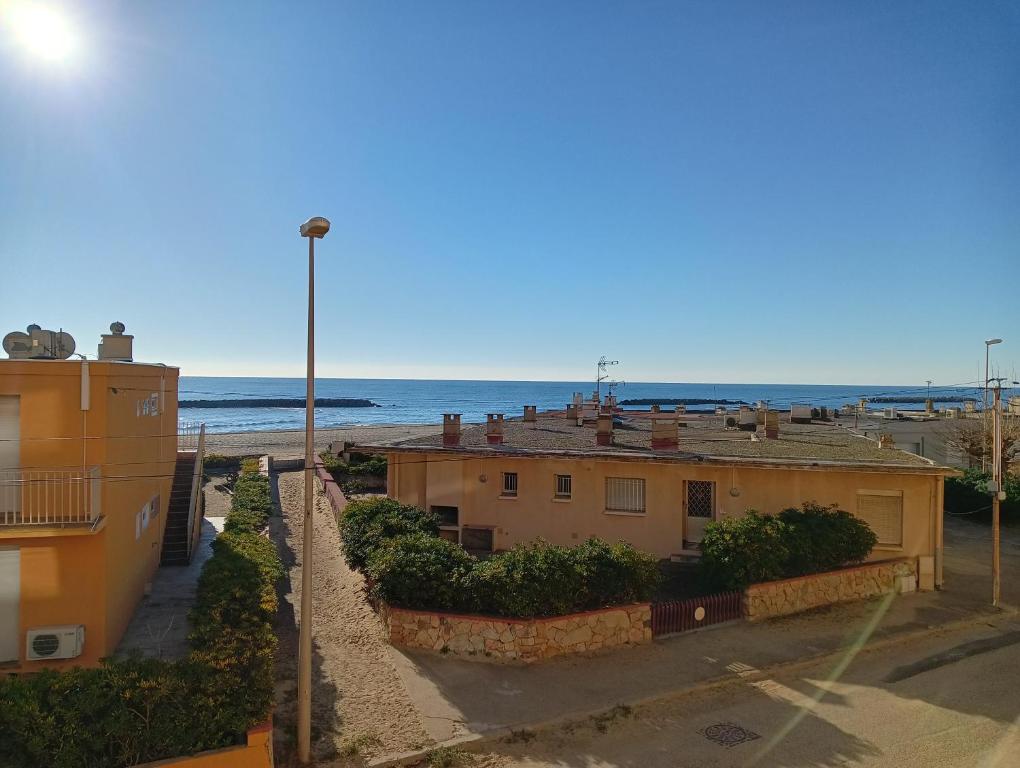 Una vista de la playa desde un balcón de un edificio. en T2 vue exceptionnelle avec accès privé à la plage, wifi, clim - dansnotreappart-com -, en Valras-Plage