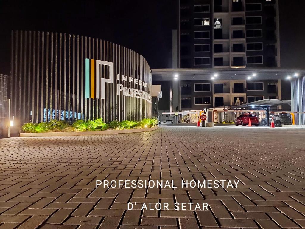 a building in a city at night with a brick road at Professional HomeStay D' Alor Setar in Alor Setar